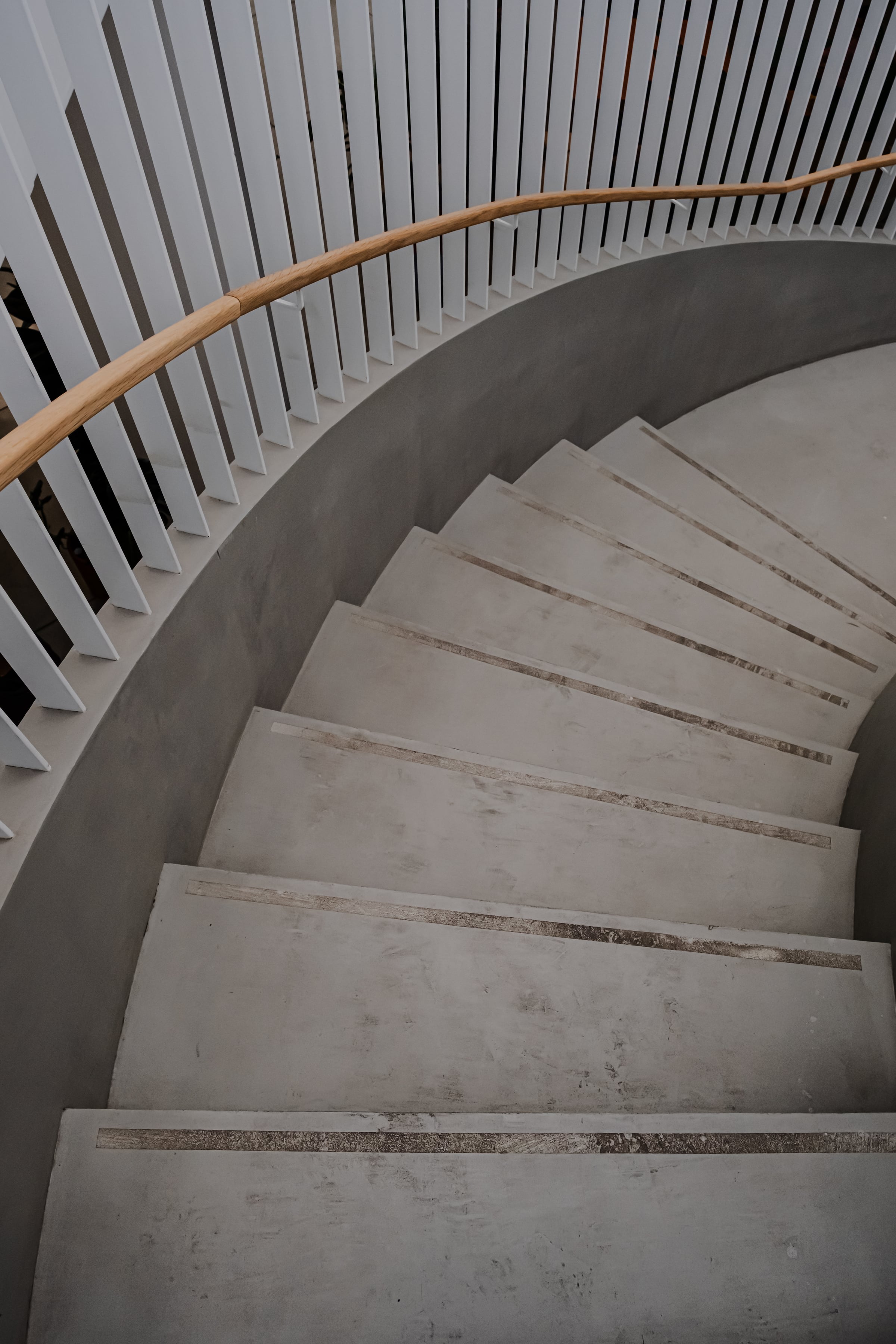 Curved spiral staircase seen from above, concrete steps