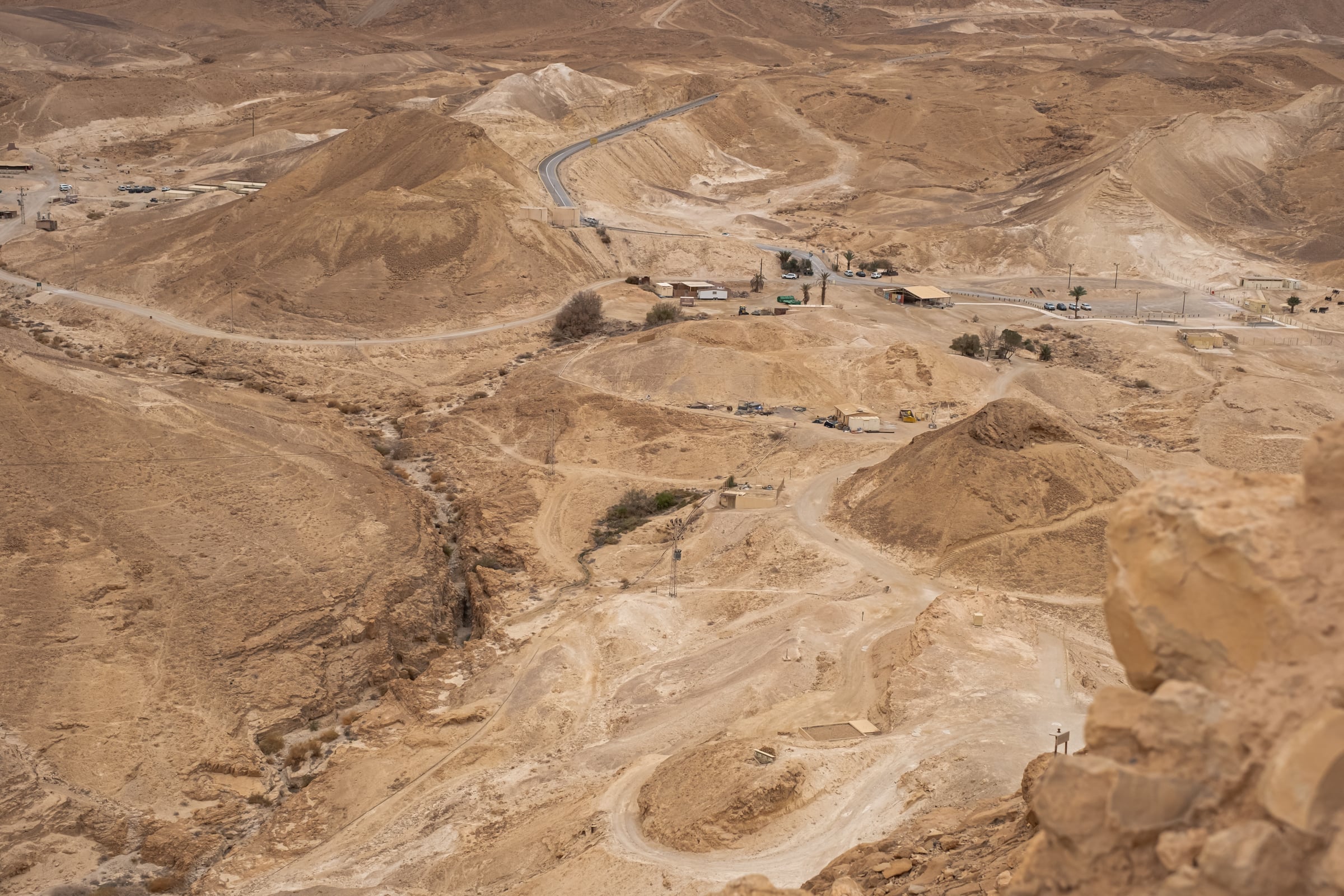 Aerial view of desert landscape near Masada with winding road