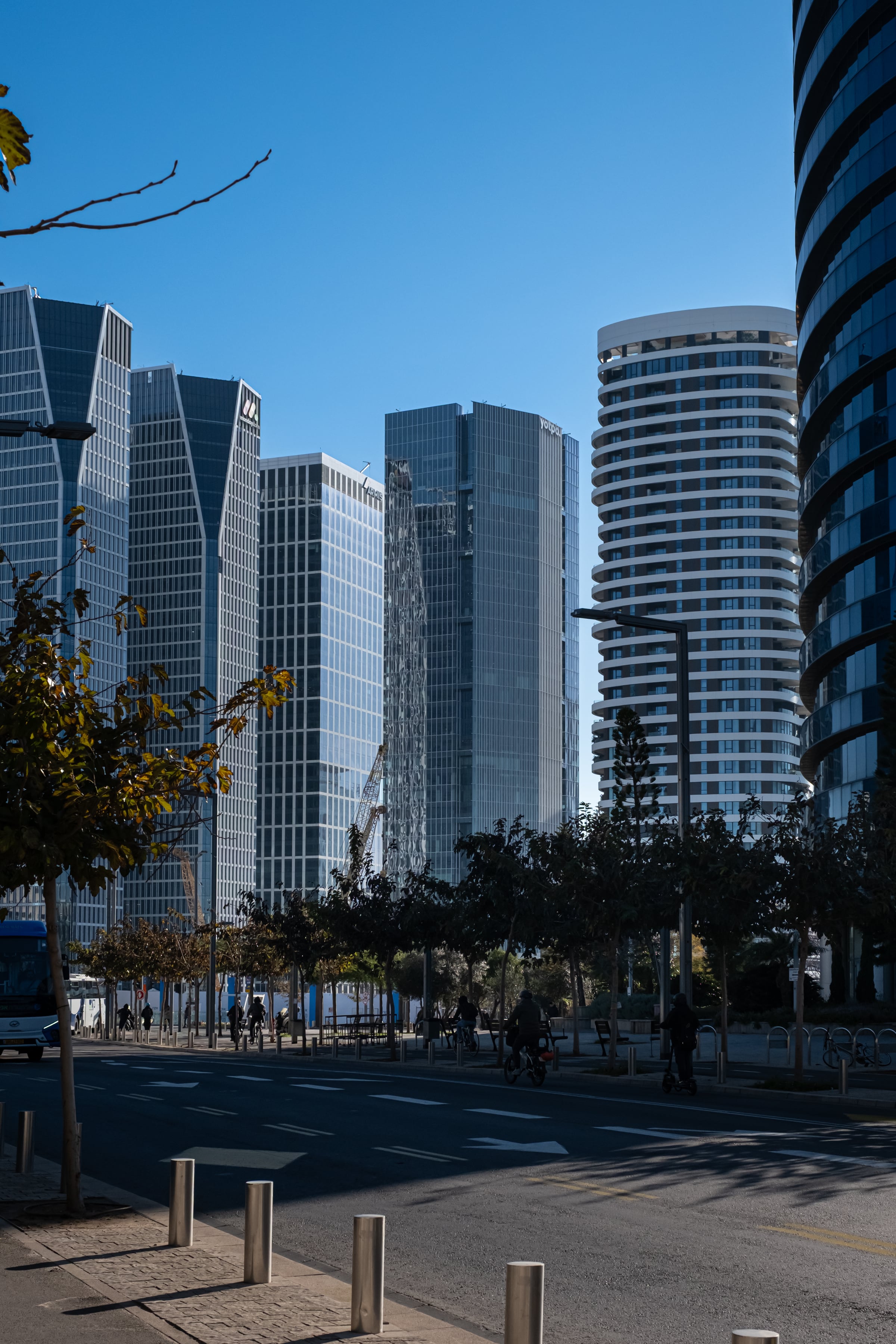 Tel Aviv glass skyscrapers on a clear blue-sky day from street level