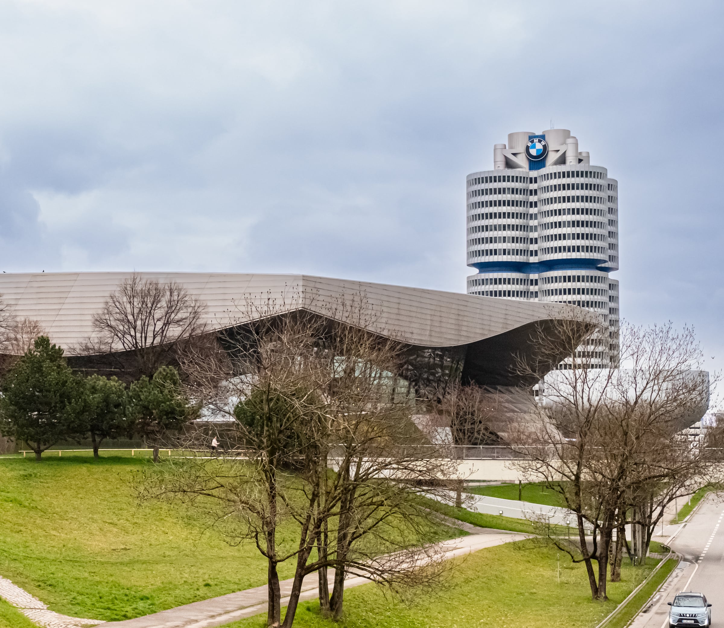 BMW headquarters cylindrical tower and futuristic museum building in Munich on overcast day