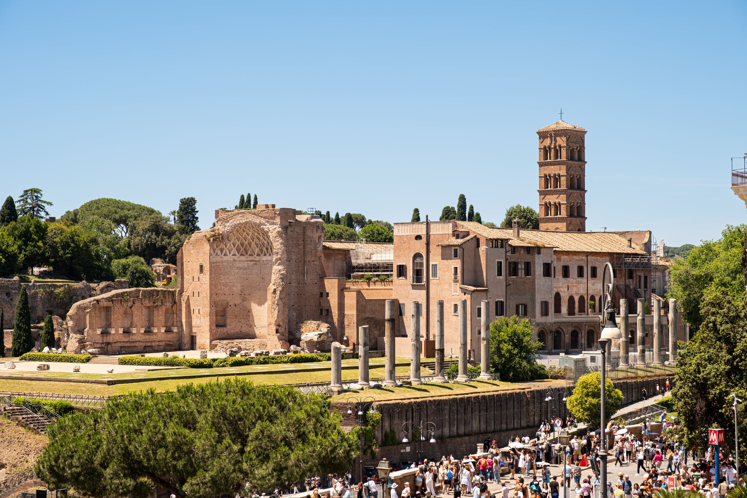 Roman Forum ruins with Temple of Venus and Roma, Basilica of Maxentius, medieval tower and tourists