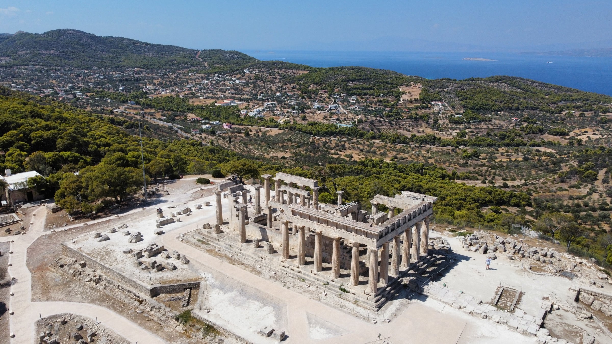Aerial drone view of Temple of Aphaia on Aegina island with Doric columns and Greek landscape and sea